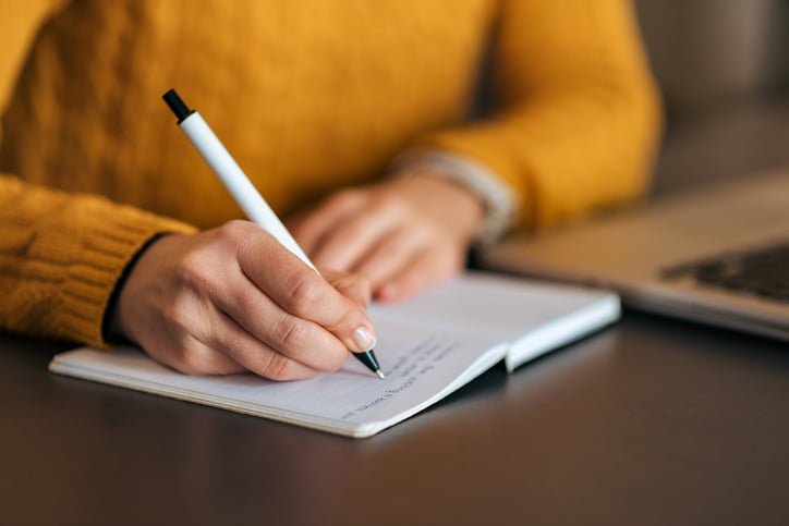 Writing in notebook. Close-up. Writing in notebook. Close-up.