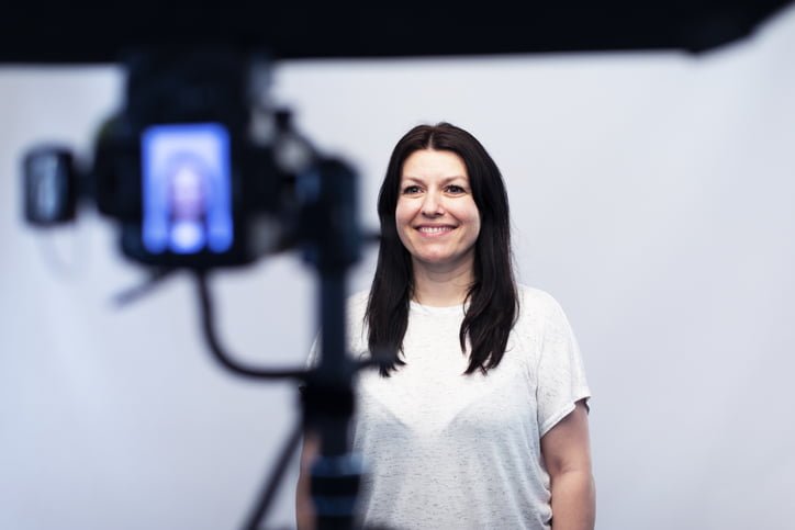 Female model standing in front of the camera at the photo studio At the photo studio a model is posing for a photograph